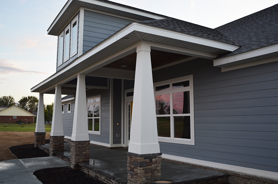 grey-blue house white trim sunset front porch