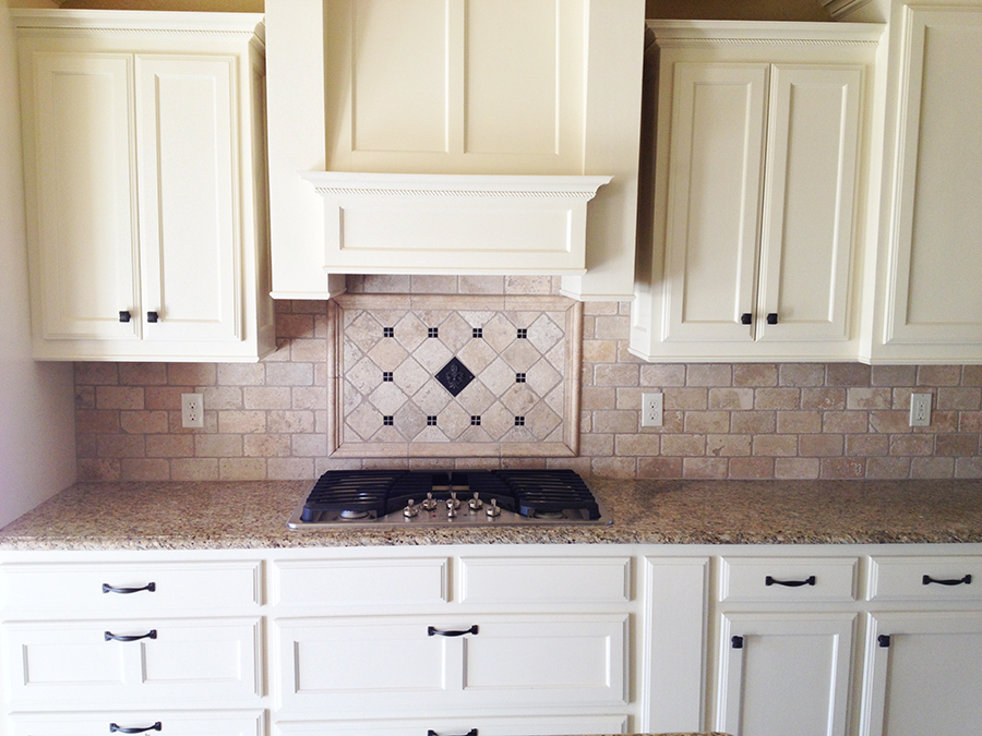 granite counter electric stove white cabinets